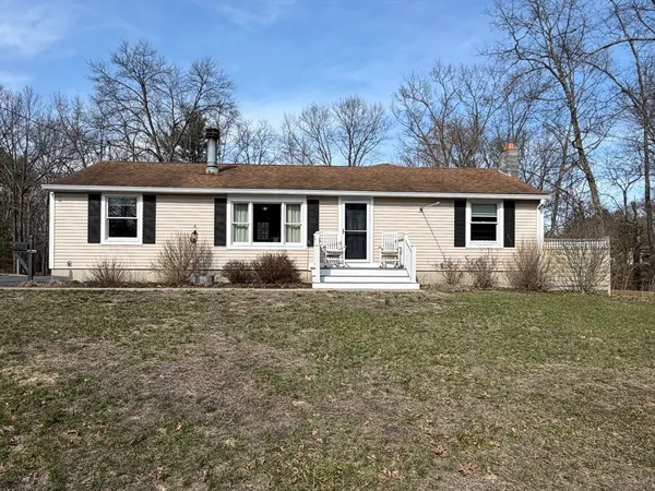 a front view of house with yard and green space