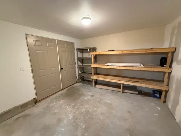 a room with furniture and white walls