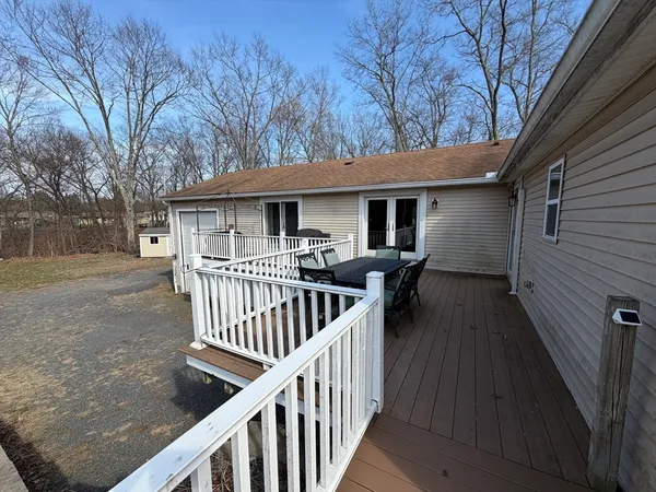 a view of a house with backyard and furniture