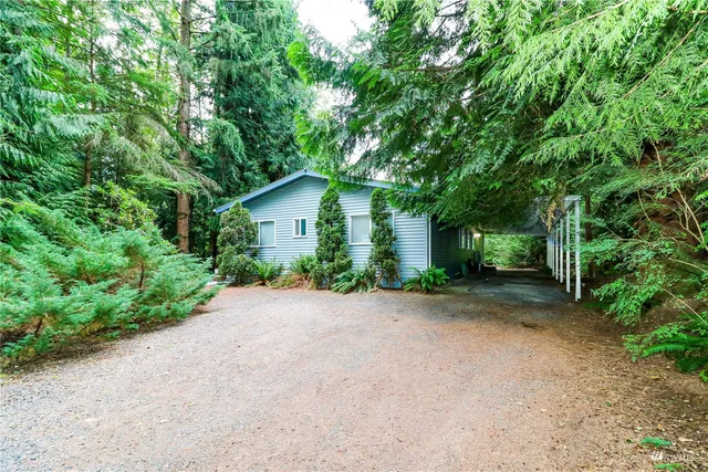 a view of a house with a tree in front of it