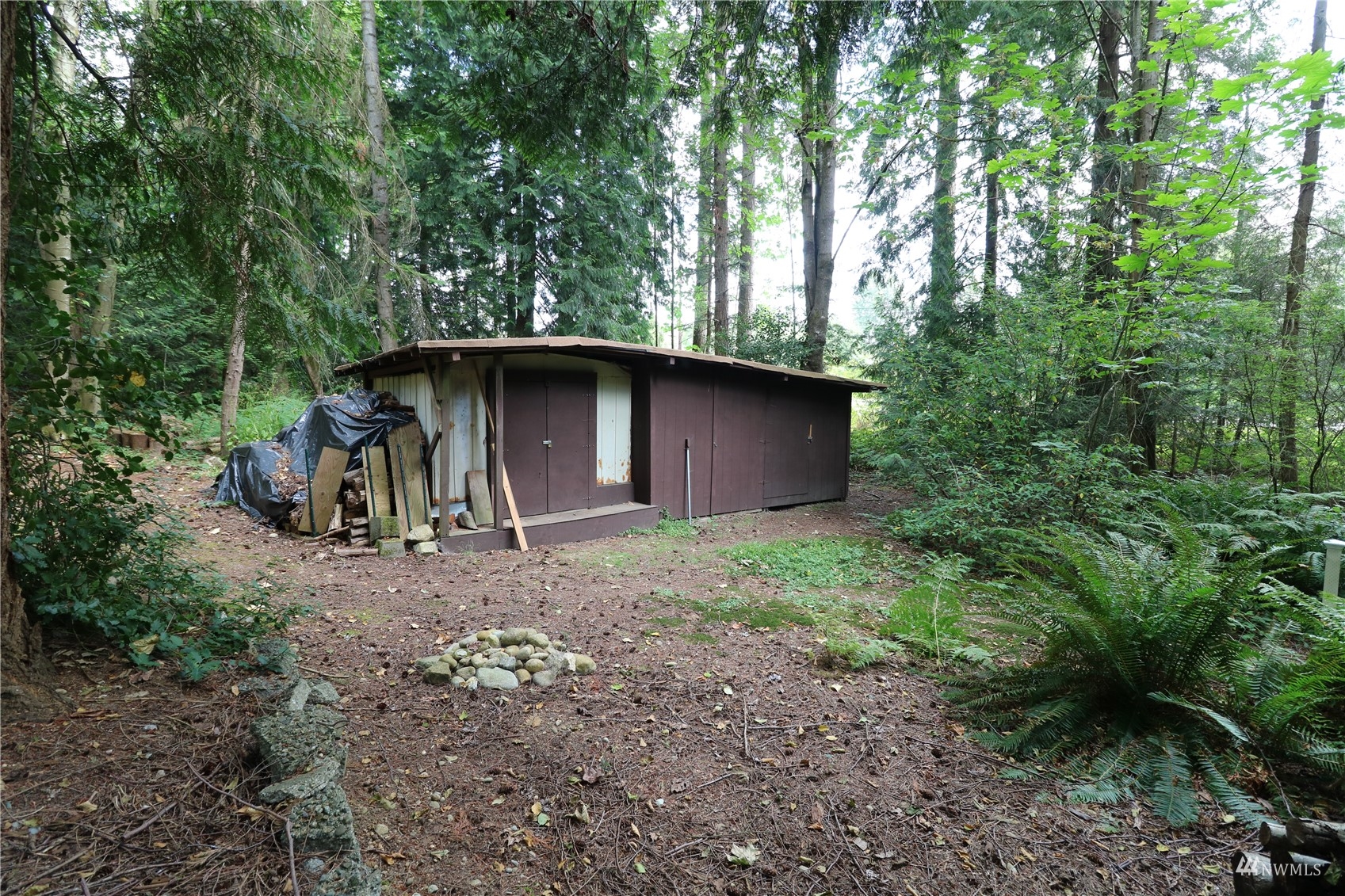16530 35th Avenue Southeast Bothell, WA 98012 - Photo 19 of 24 a view of a barn in the middle of a forest