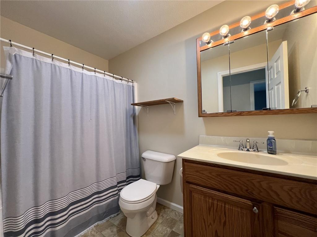 43 Maple Street Uniontown, PA 15401 - Photo 14 of 26 a bathroom with a toilet a sink and a mirror