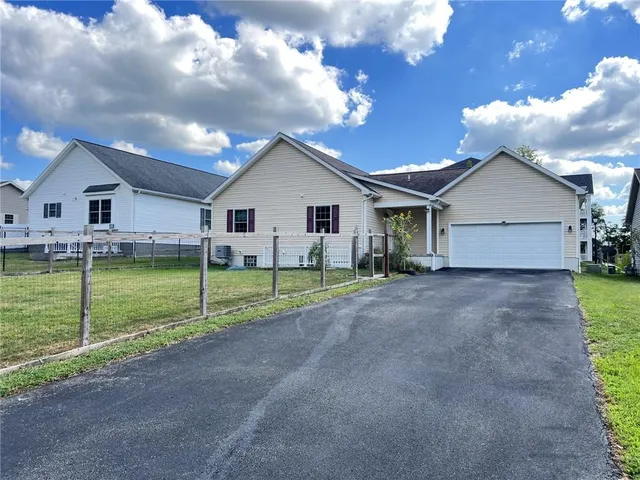 a view of a house with a yard and large tree