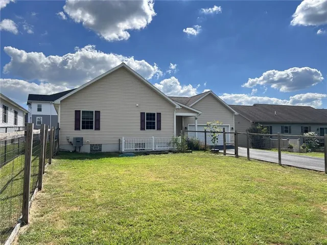 a view of a house with a yard and sitting area