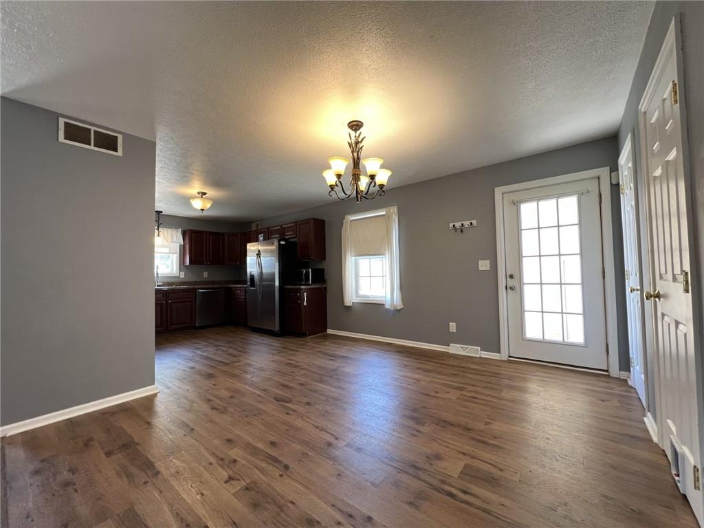 43 Maple Street Uniontown, PA 15401 - Photo 7 of 26 an empty room with wooden floor fireplace and windows