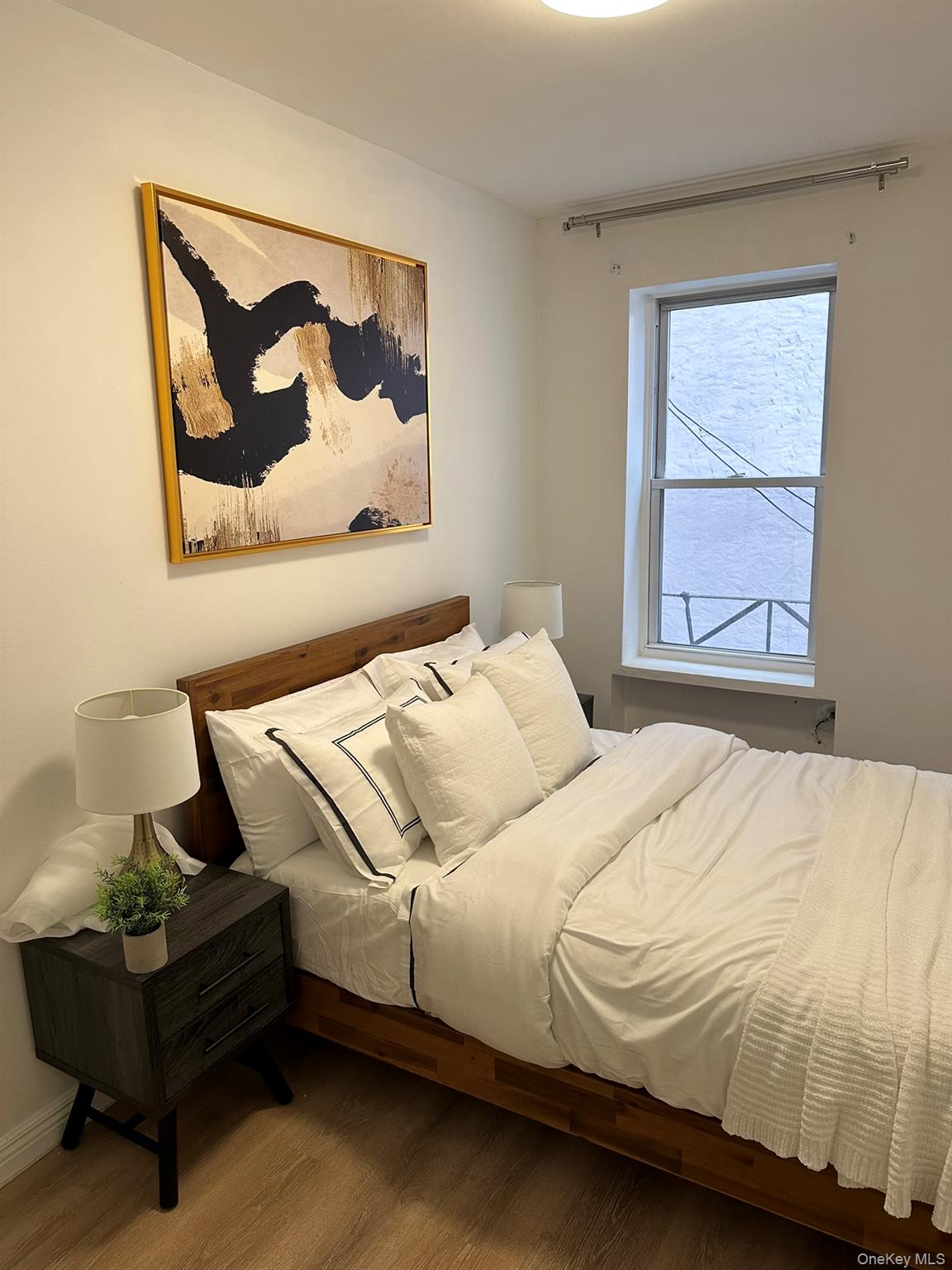 1435 2nd Avenue Manhattan, NY 10021 - Photo 27 of 33 a bedroom with a bed and wooden floor