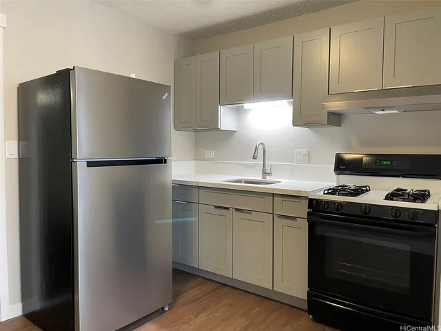a kitchen with a refrigerator stove and cabinets