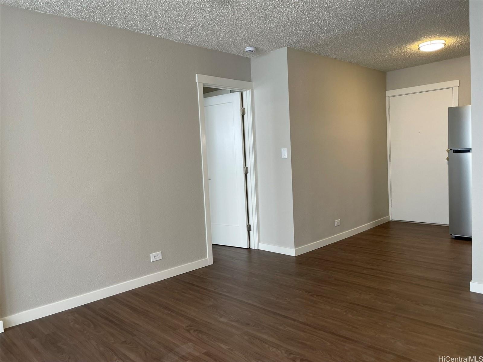 620 Sheridan Street, Unit 404 Honolulu, HI 96814 - Photo 6 of 10 a view of an empty room with wooden floor