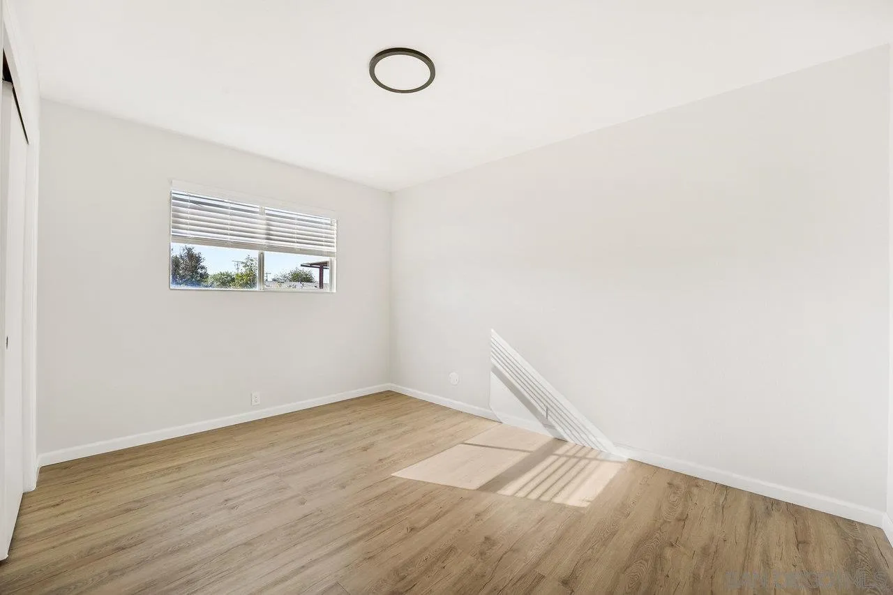 1355 Bluebell Way El Cajon, CA 92021 - Photo 18 of 33 an empty room with wooden floor and windows