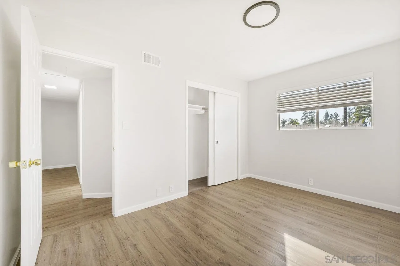 1355 Bluebell Way El Cajon, CA 92021 - Photo 19 of 33 an empty room with wooden floor and windows