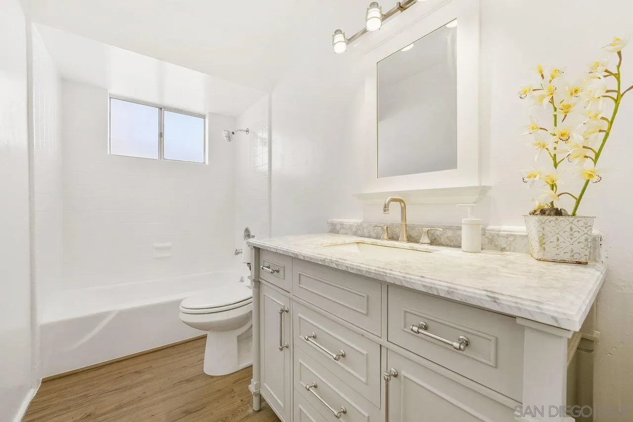 1355 Bluebell Way El Cajon, CA 92021 - Photo 21 of 33 a bathroom with a granite countertop sink a toilet and a bathtub