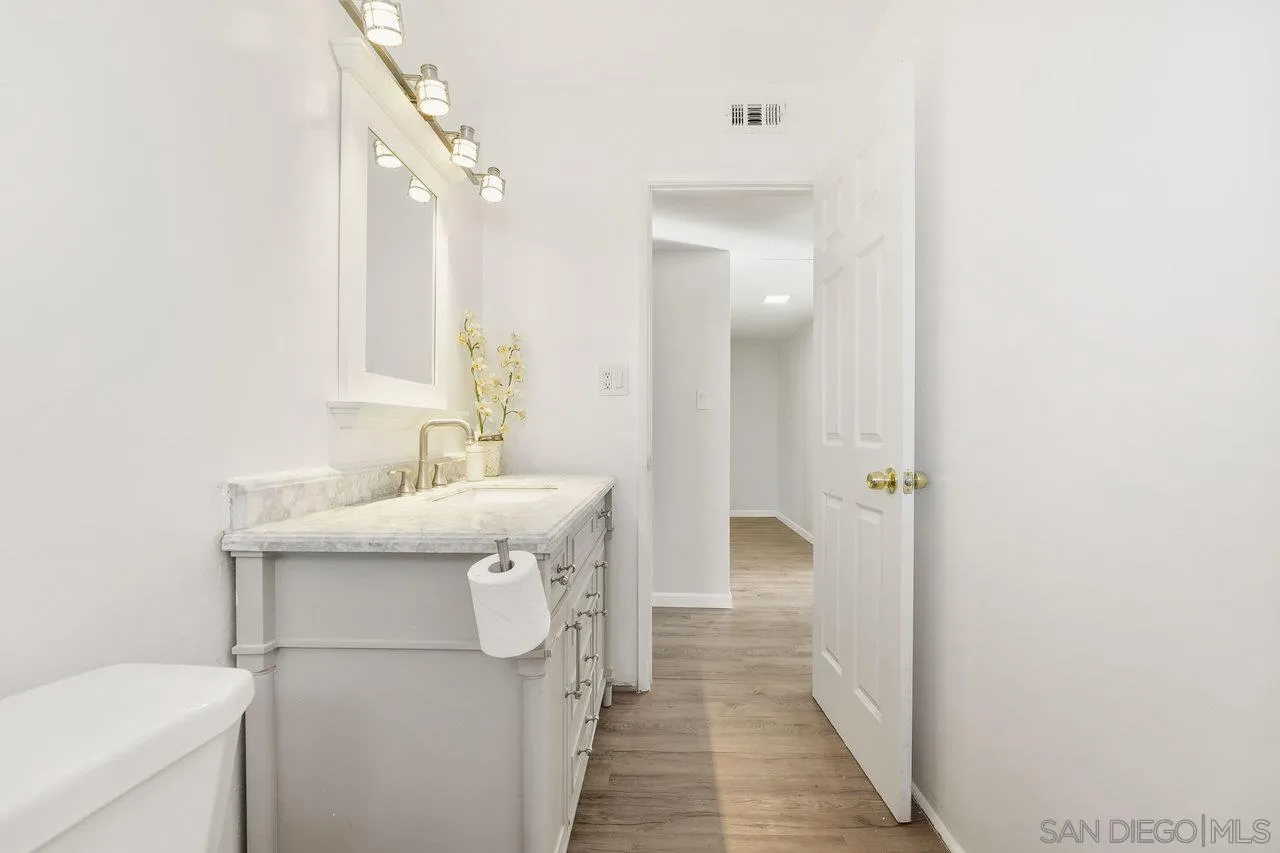 1355 Bluebell Way El Cajon, CA 92021 - Photo 22 of 33 a en suite bathroom with a sink a mirror and a toilet