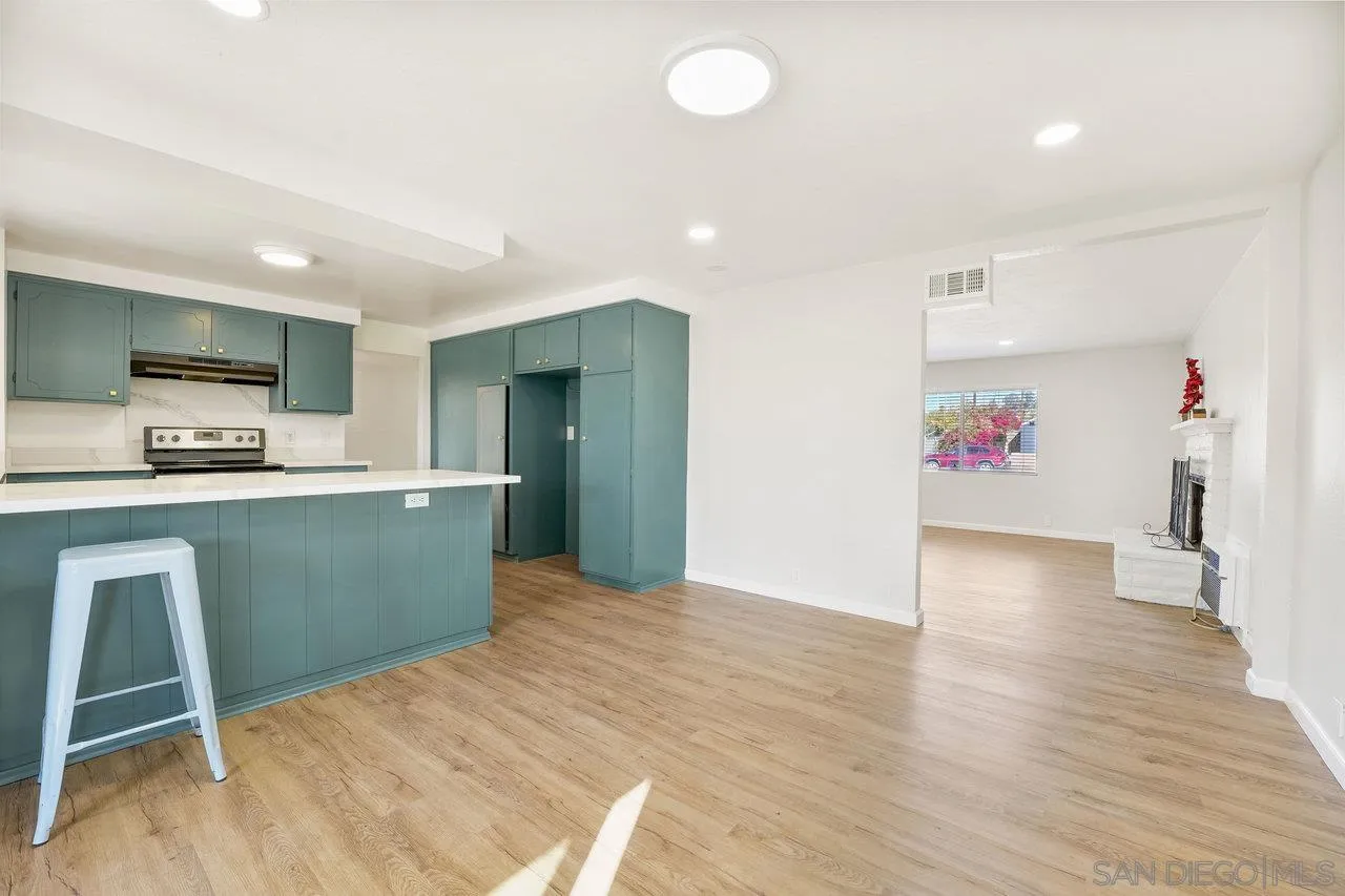 1355 Bluebell Way El Cajon, CA 92021 - Photo 10 of 33 a kitchen with stainless steel appliances kitchen island granite countertop a sink and cabinets