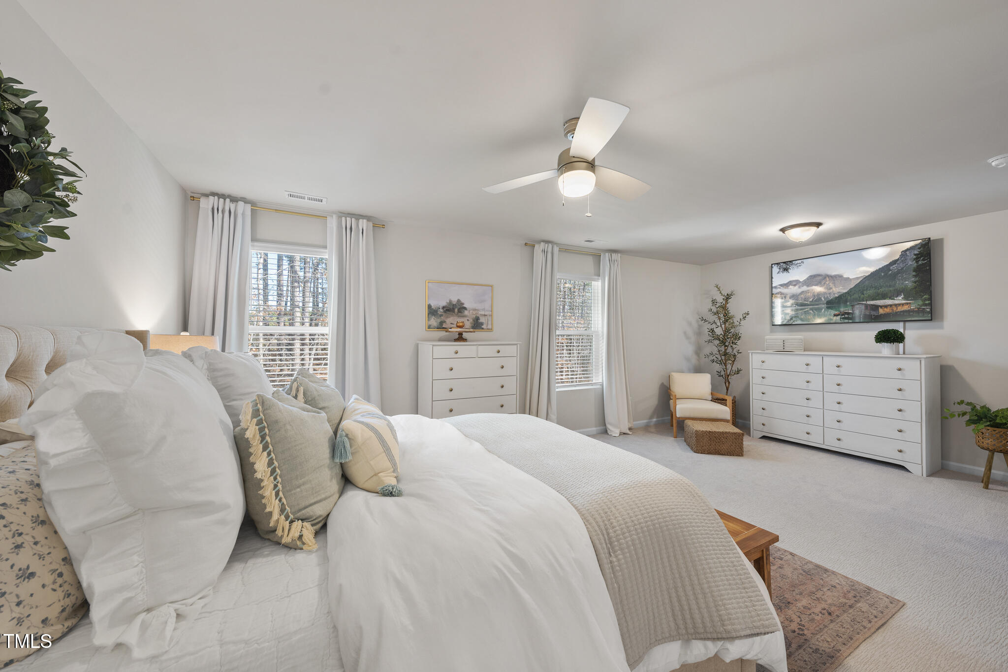 3408 Dropseed Drive Apex, NC 27502 - Photo 17 of 27 a spacious bedroom with a bed and ceiling fan
