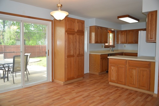 7 East Oltendorf Road Streamwood, IL 60107 - Photo 5 of 17 a kitchen with wooden floors and white cabinets