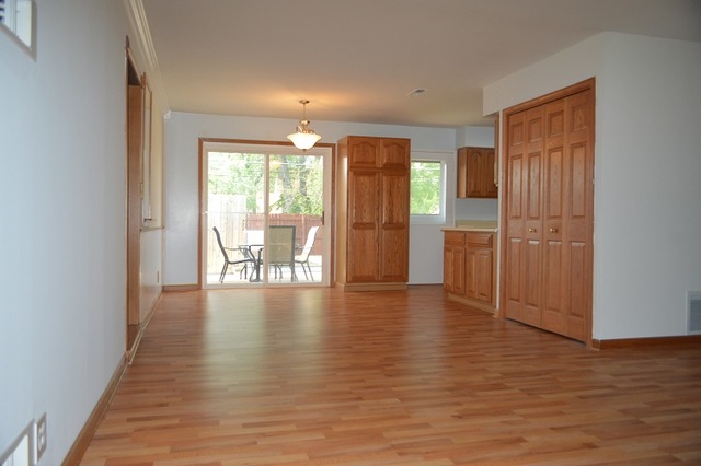 7 East Oltendorf Road Streamwood, IL 60107 - Photo 7 of 17 a view of an empty room with wooden floor and a window