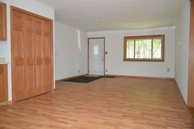 7 East Oltendorf Road Streamwood, IL 60107 - Photo 8 of 17 a view of empty room with wooden floor and fan