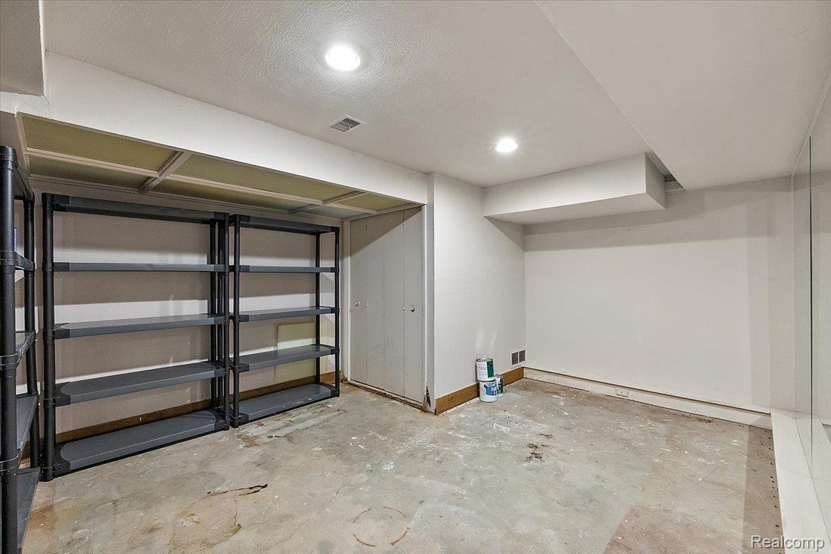 1051 Devonshire Road Grosse Pointe, MI 48230 - Photo 65 of 99 Unfinished basement room featuring exposed concrete flooring, white painted walls, and overhead recessed lighting