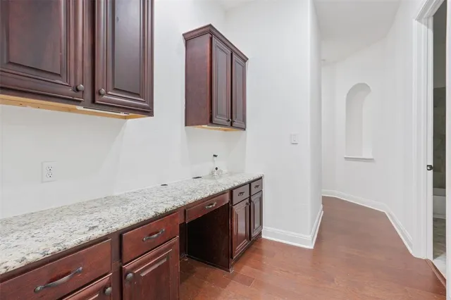 a kitchen with granite countertop a sink and cabinets