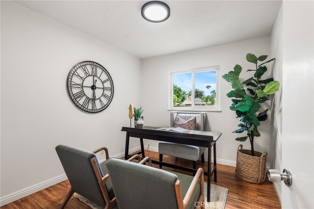 13361 Roxey Drive Garden Grove, CA 92843 - Photo 15 of 31 a living room with furniture a clock and a potted plant