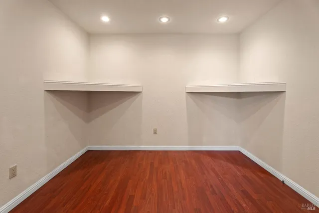 an empty room with wooden floor