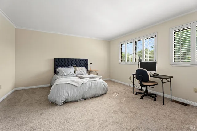 a bedroom with a bed and chair