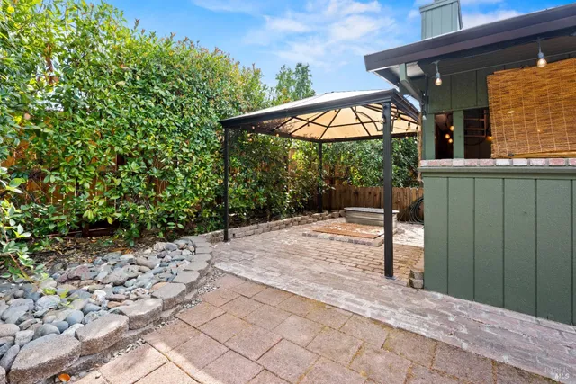 a backyard of a house with table and chairs
