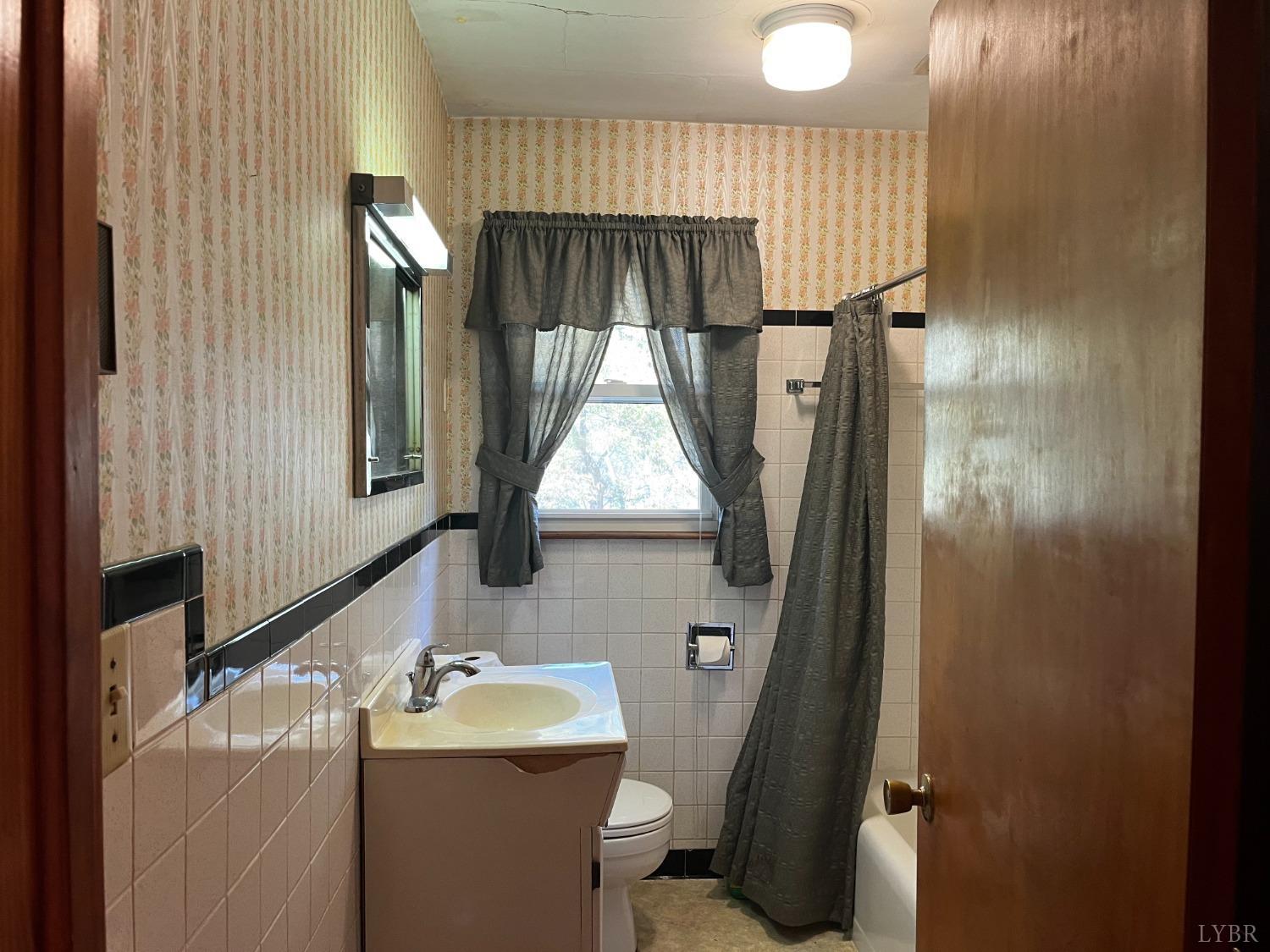 1089 Howell Ridge Lane Vinton, VA 24179 - Photo 12 of 39 a bathroom with a sink toilet and mirror
