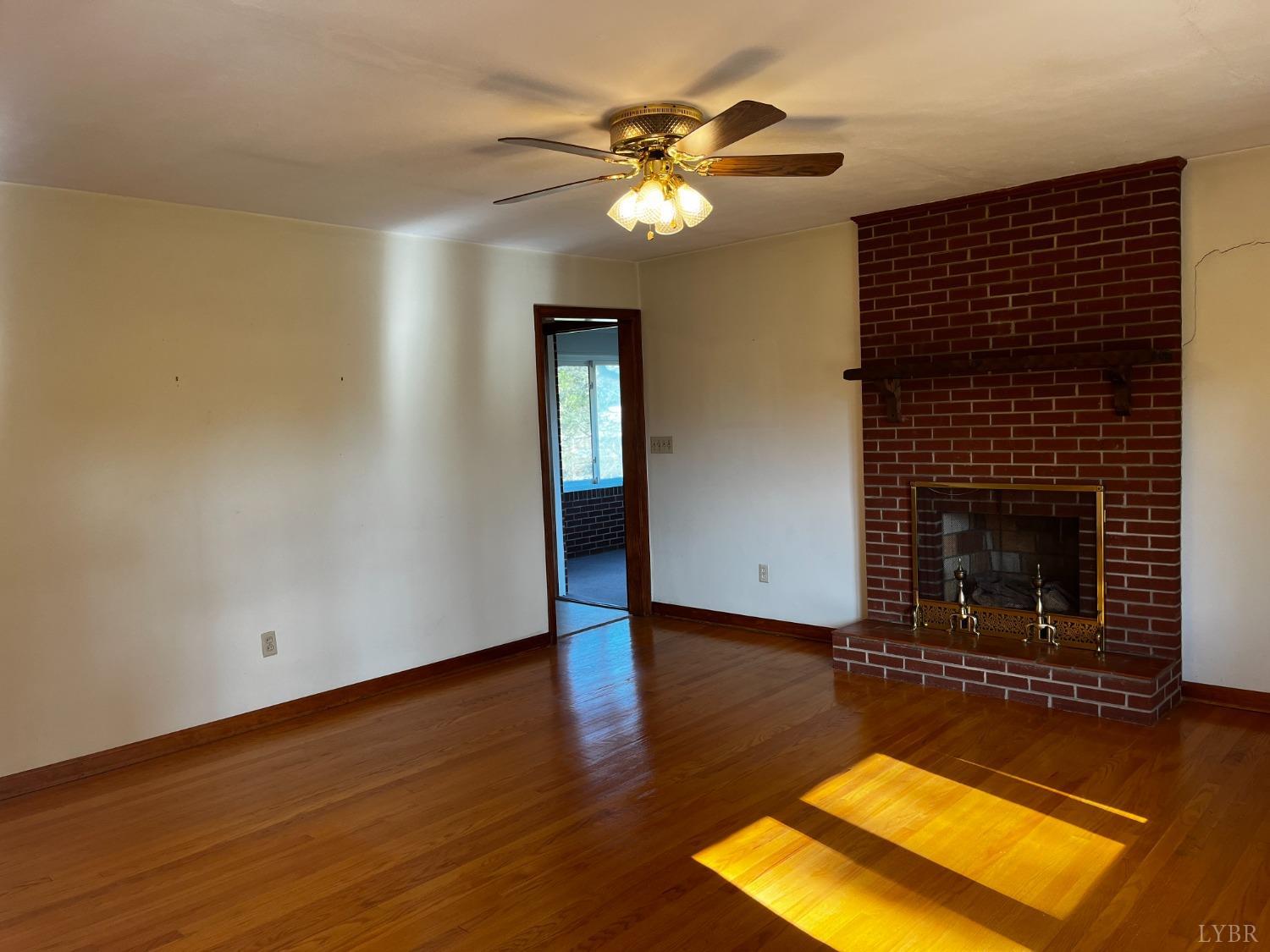 1089 Howell Ridge Lane Vinton, VA 24179 - Photo 3 of 39 a view of a livingroom with a fireplace and wooden floor