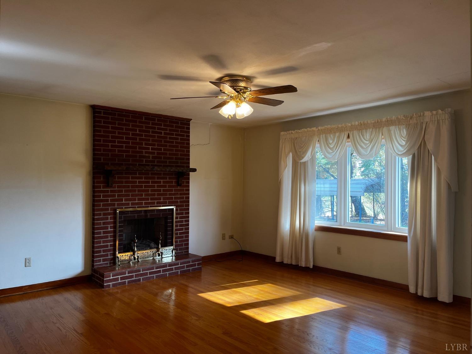 1089 Howell Ridge Lane Vinton, VA 24179 - Photo 5 of 39 an empty room with windows fireplace and a sink