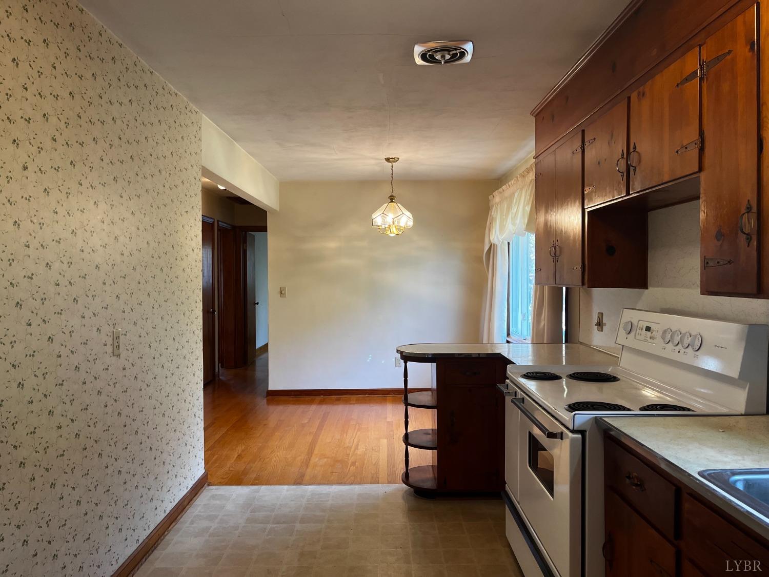 1089 Howell Ridge Lane Vinton, VA 24179 - Photo 7 of 39 a kitchen with a sink and a refrigerator