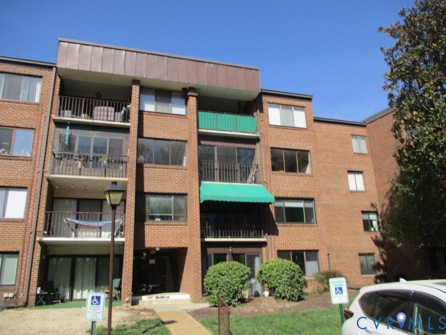 1507 Bronwyn Road, Unit 301 Henrico, VA 23238 - Photo 1 of 41 a front view of a residential apartment building with a yard