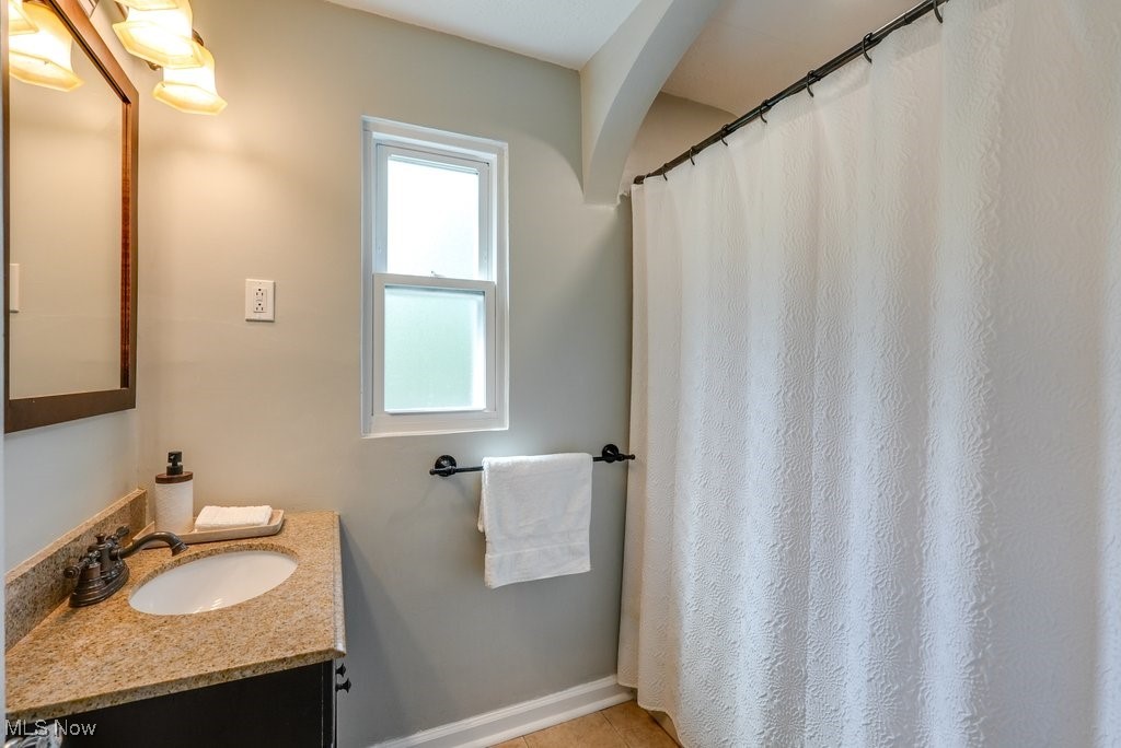 2340 Canterbury Road University Heights, OH 44118 - Photo 20 of 29 Full bath with vanity, baseboards, tub/shower combo and tile patterned flooring