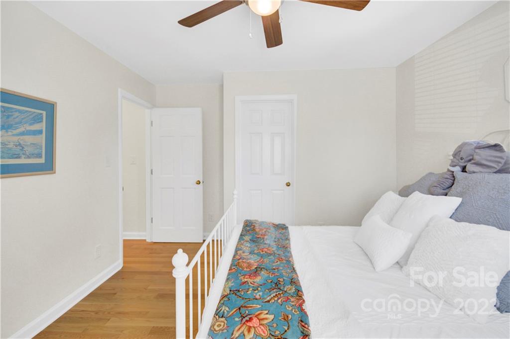 4063 Lake Shore Road South Denver, NC 28037 - Photo 27 of 47 a bedroom with a bed and a painting on the wall