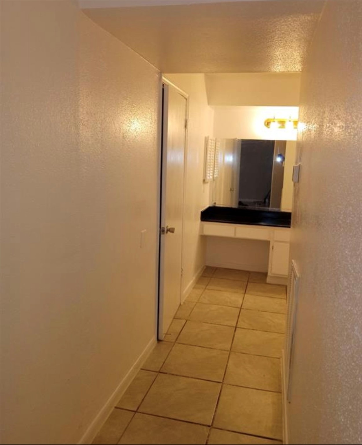 5625 Antoine Drive, Unit 413 Houston, TX 77091 - Photo 7 of 14 a view of hallway with bathroom and mirror