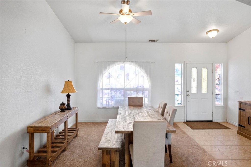 11025 El Esteban Road Phelan, CA 92371 - Photo 8 of 54 a view of a dining room with furniture window and wooden floor