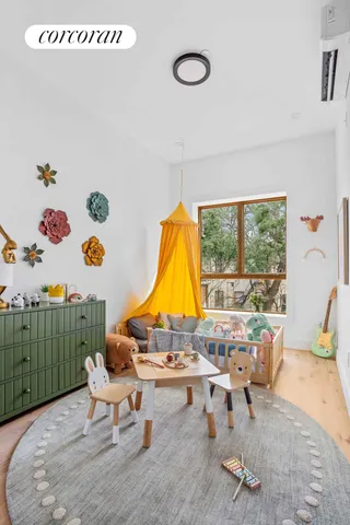 a bedroom with furniture and a large window