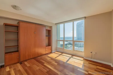 a view of empty room with wooden floor and entryway