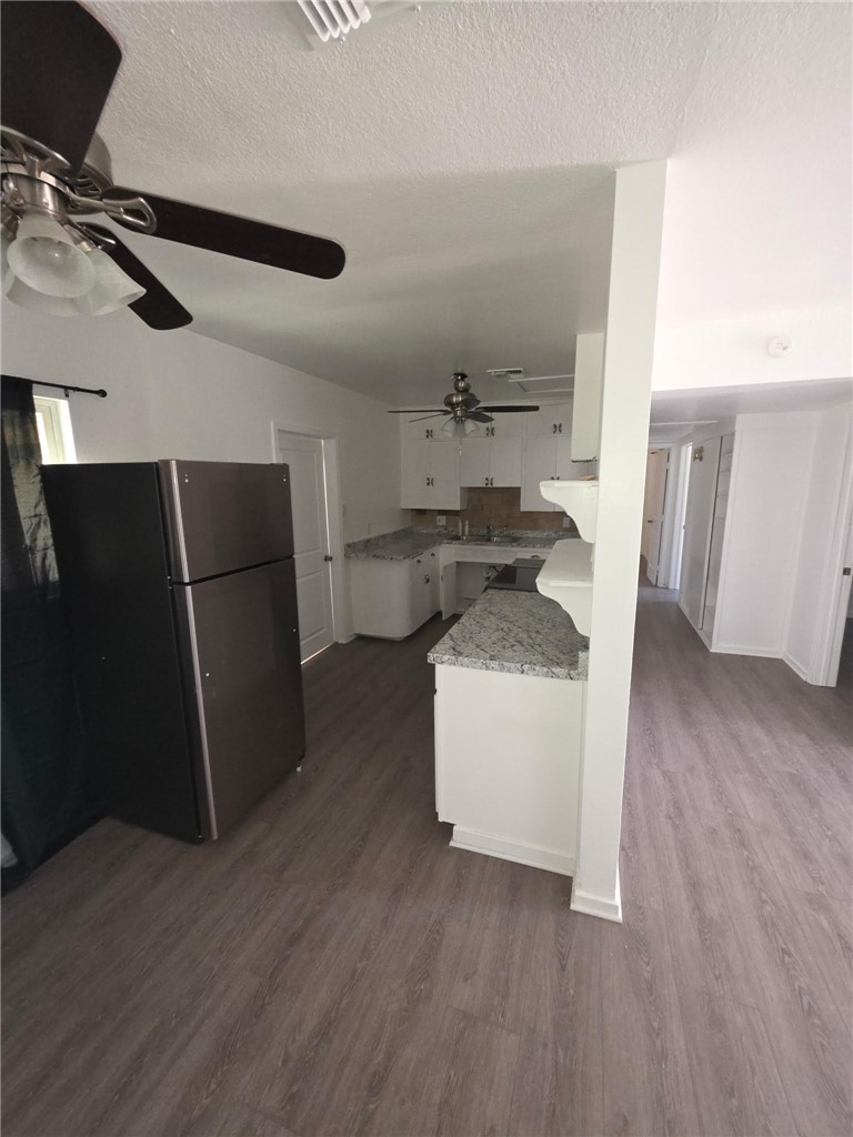 512 E Street Needles, CA 92363 - Photo 17 of 20 a living room with stainless steel appliances a wooden floor