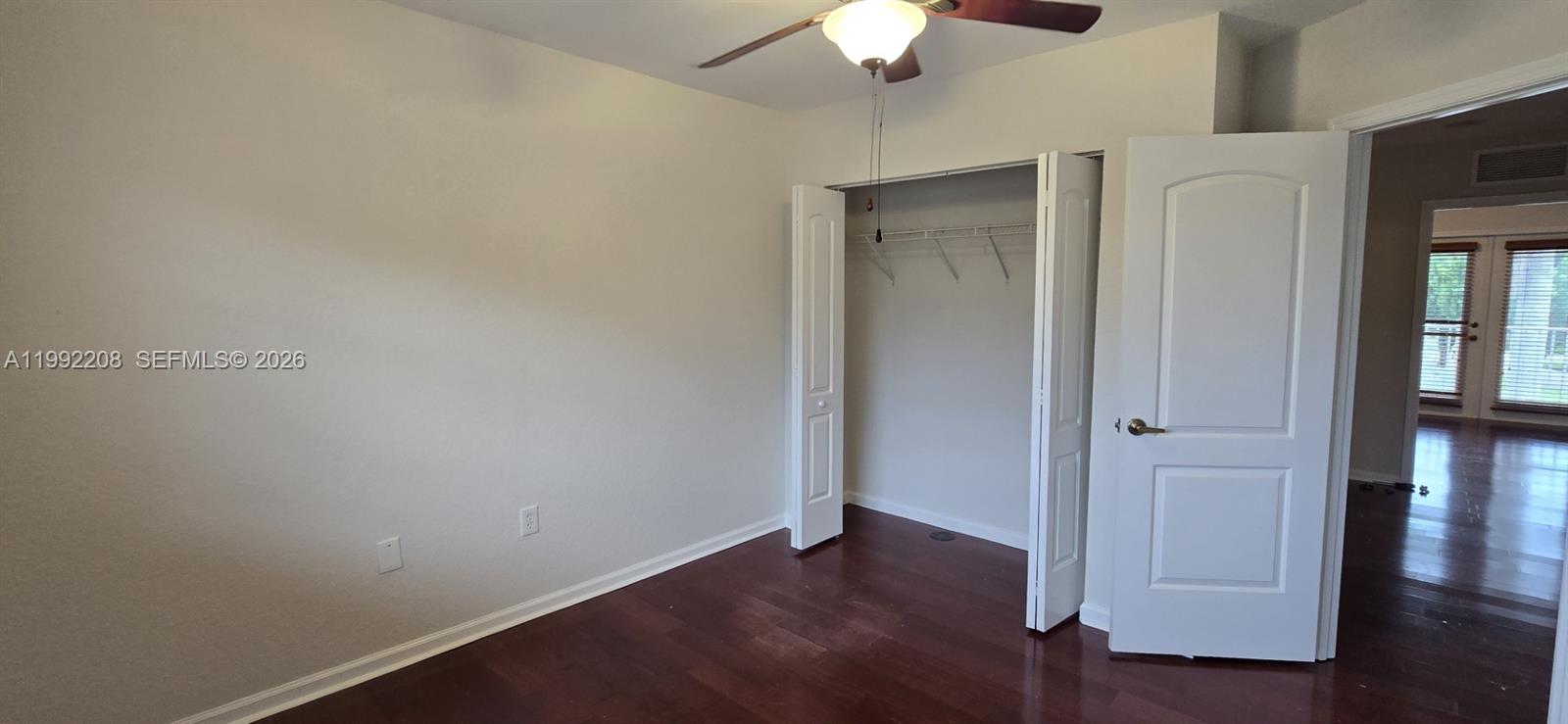 14067 Southwest 272nd Street Homestead, FL 33032 - Photo 11 of 36 an empty room with wooden floor closet and windows