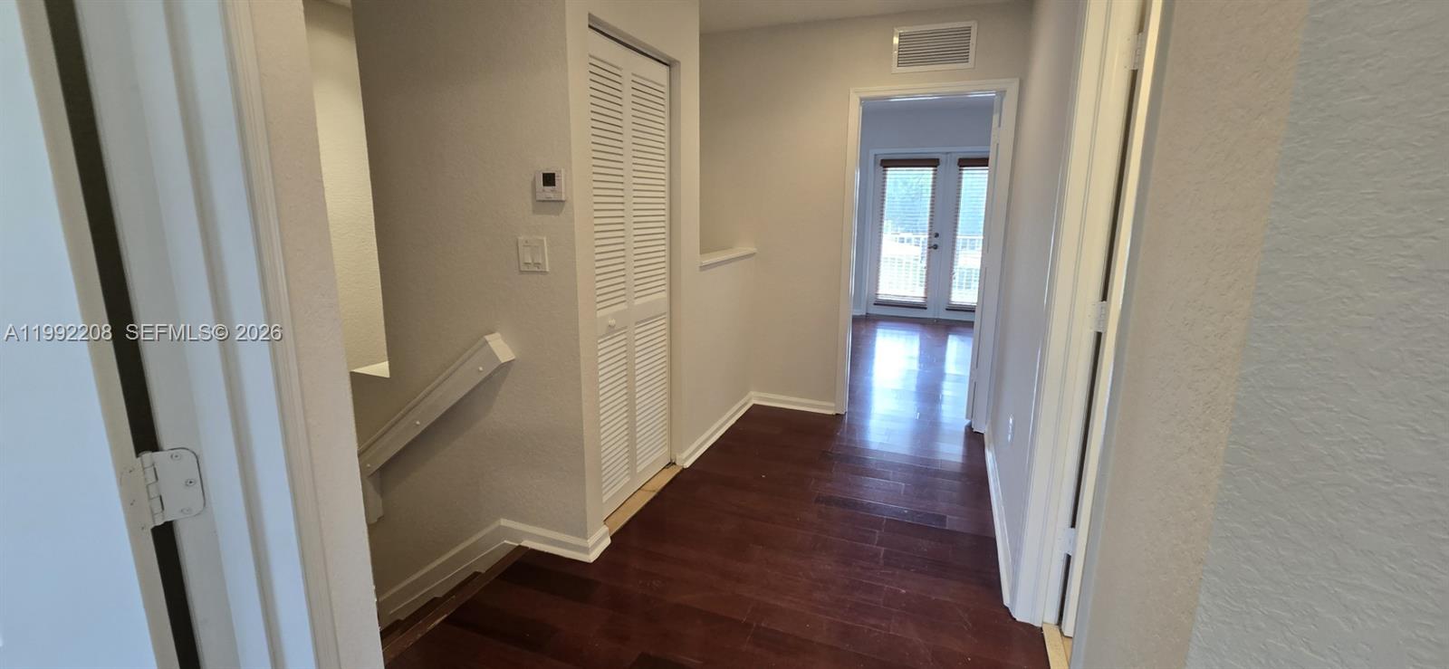 14067 Southwest 272nd Street Homestead, FL 33032 - Photo 14 of 36 a view of a hallway with wooden floor and stairs