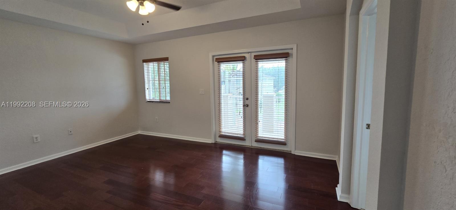 14067 Southwest 272nd Street Homestead, FL 33032 - Photo 15 of 36 a view of an empty room with wooden floor and a window