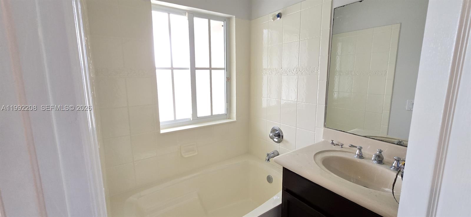 14067 Southwest 272nd Street Homestead, FL 33032 - Photo 18 of 36 a bathroom with a sink and a bathtub