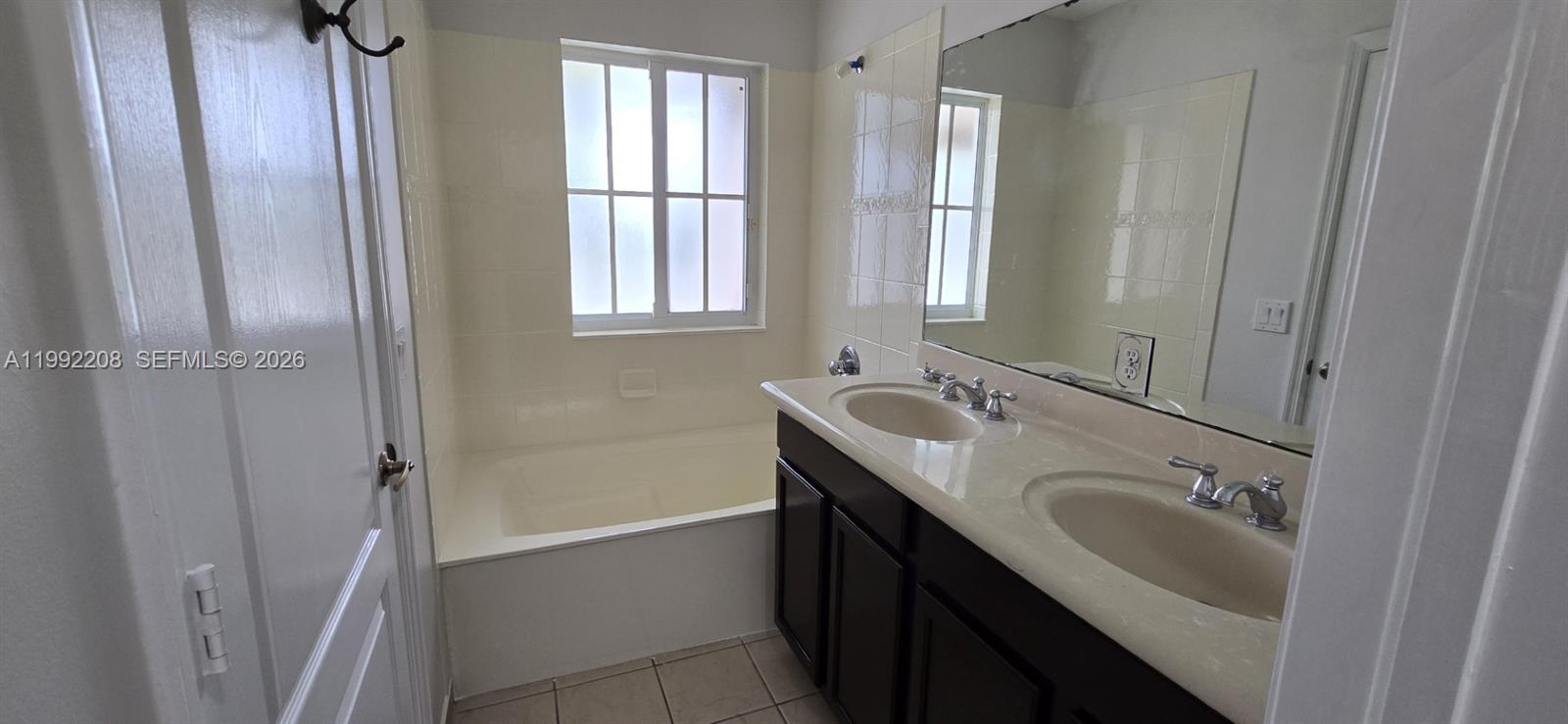 14067 Southwest 272nd Street Homestead, FL 33032 - Photo 19 of 36 a bathroom with a sink a mirror and a bathtub