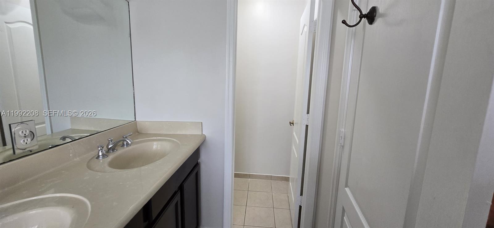 14067 Southwest 272nd Street Homestead, FL 33032 - Photo 20 of 36 a bathroom with a sink and mirror