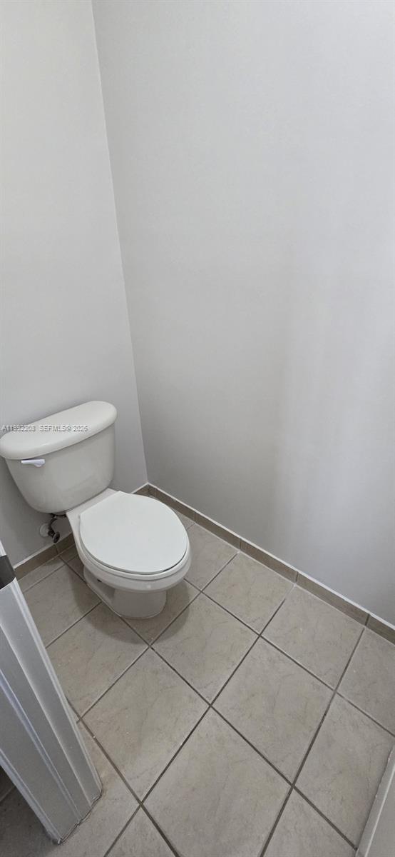 14067 Southwest 272nd Street Homestead, FL 33032 - Photo 21 of 36 a white toilet sitting next to a white cabinet