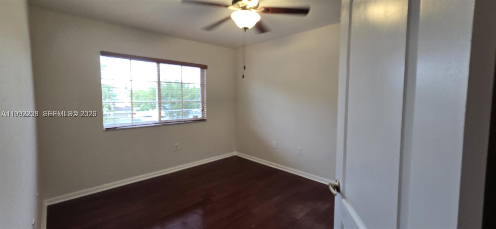 14067 Southwest 272nd Street Homestead, FL 33032 - Photo 10 of 36 an empty room with a window