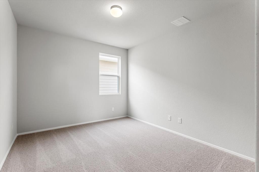 2617 Totley Road Pflugerville, TX 78660 - Photo 16 of 38 Unfurnished room with light colored carpet and baseboards