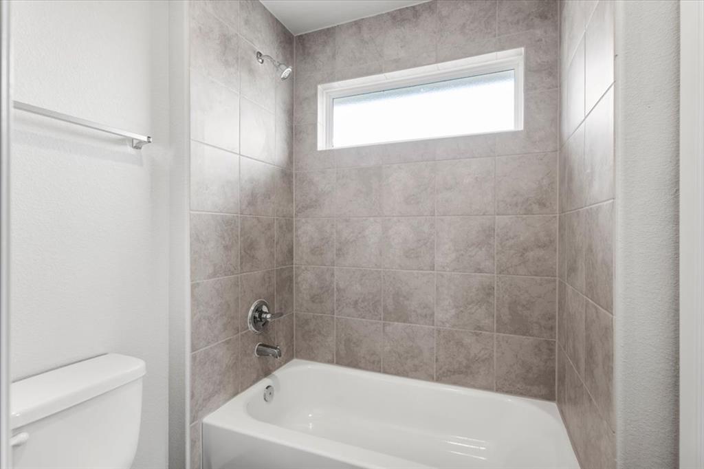 2617 Totley Road Pflugerville, TX 78660 - Photo 27 of 38 Bathroom featuring tub / shower combination and toilet