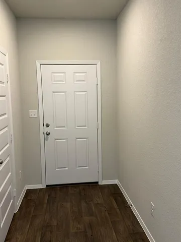 an empty room with wooden floor and closet